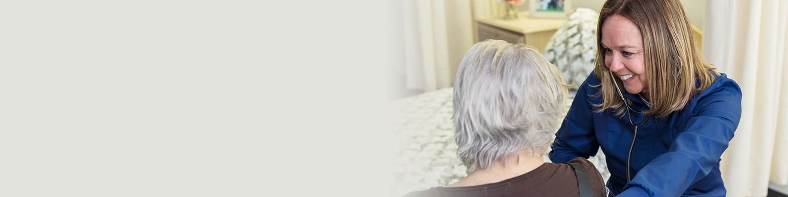 A caregiver with an elderly resident at Delhi Post-Acute