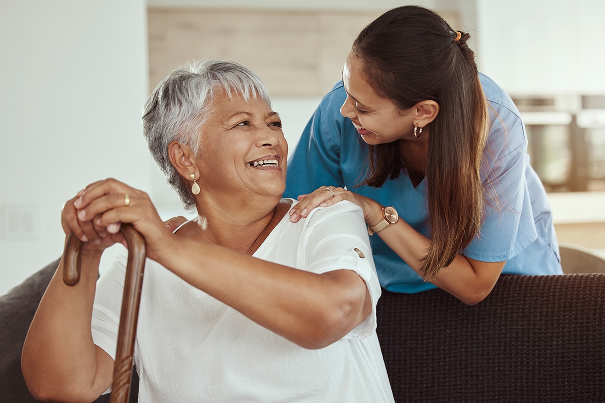 senior woman with caregiver smiling